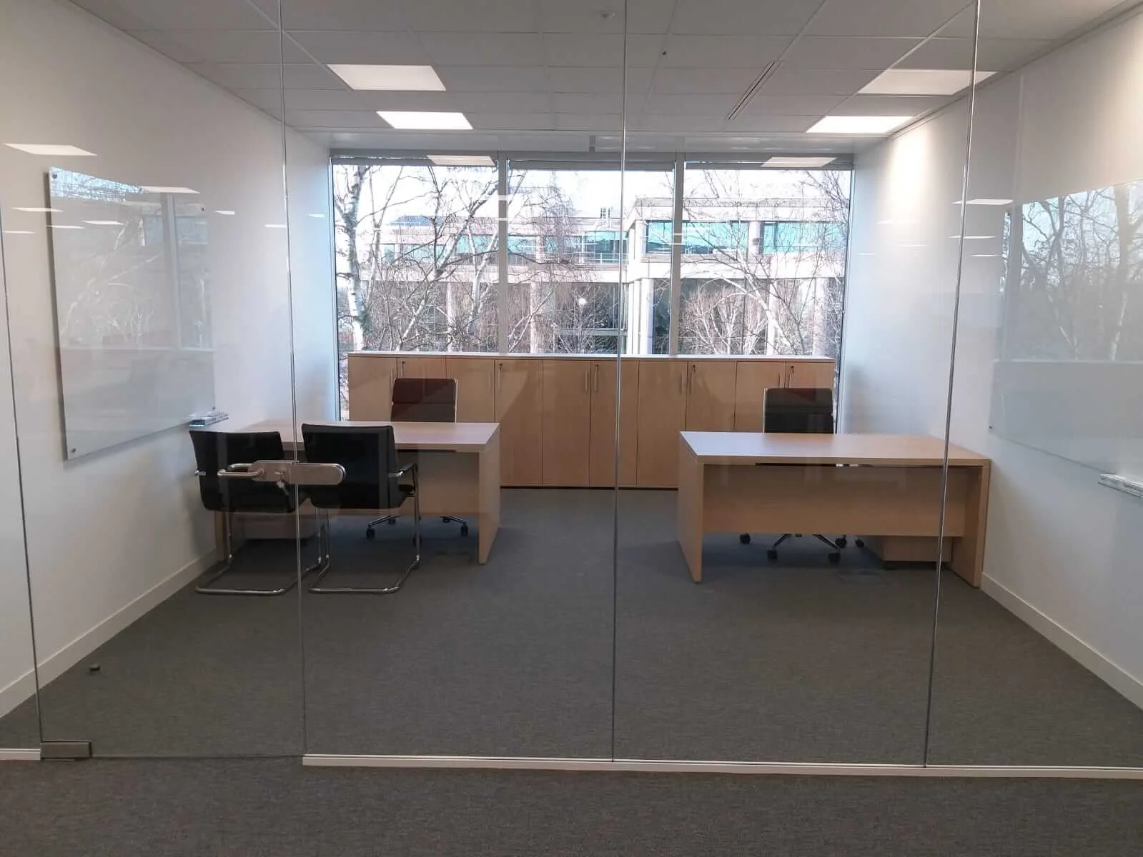 Oppo office space with designer single and back to back desks chairs and glass partitions