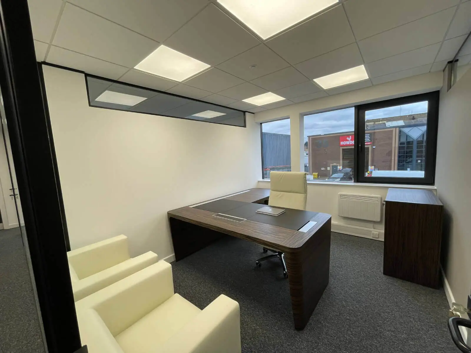 IOC office space with designer furniture and single glazed framed glass doors 2