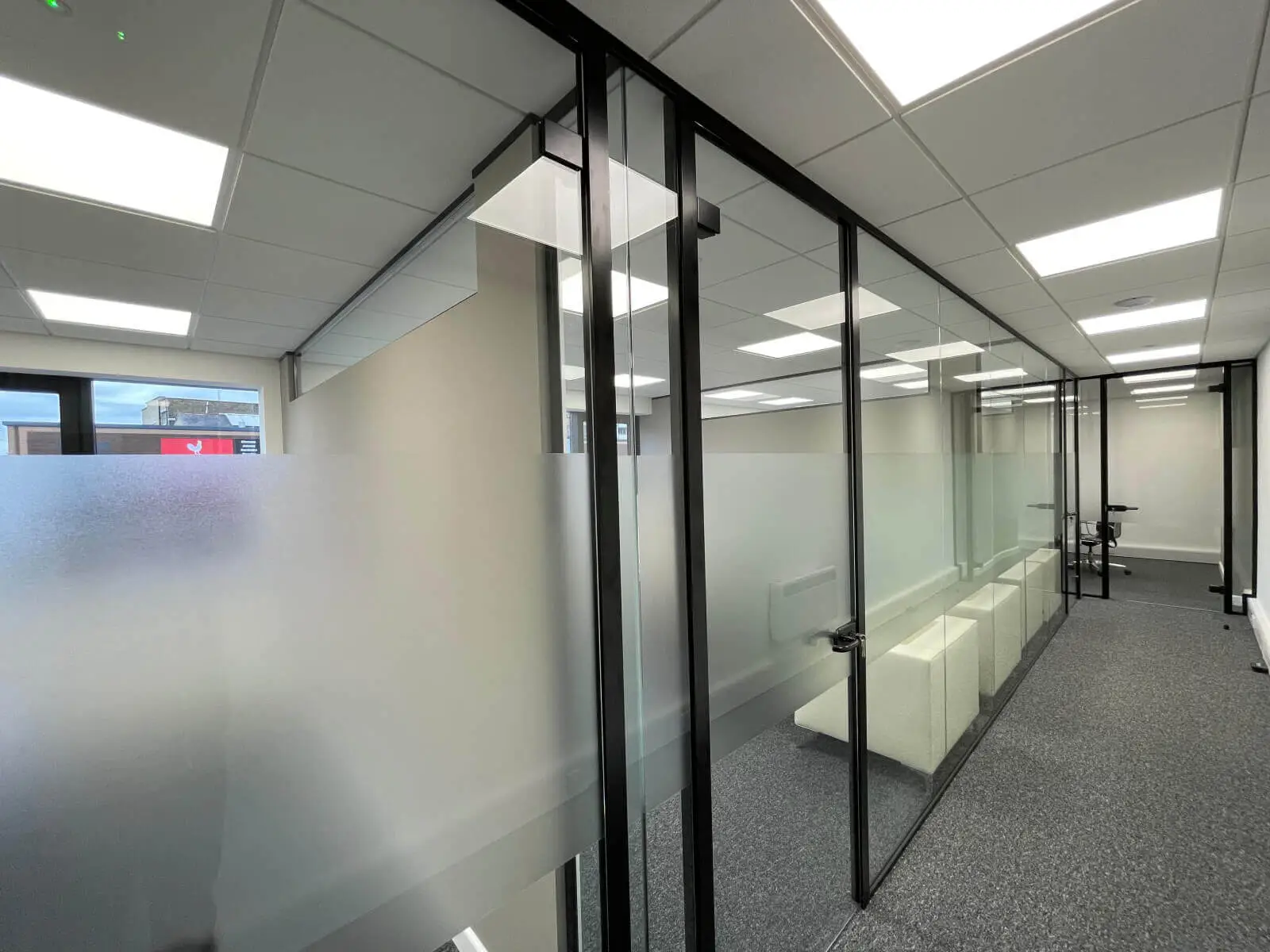 IOC office space with designer furniture and single glazed framed glass doors 26