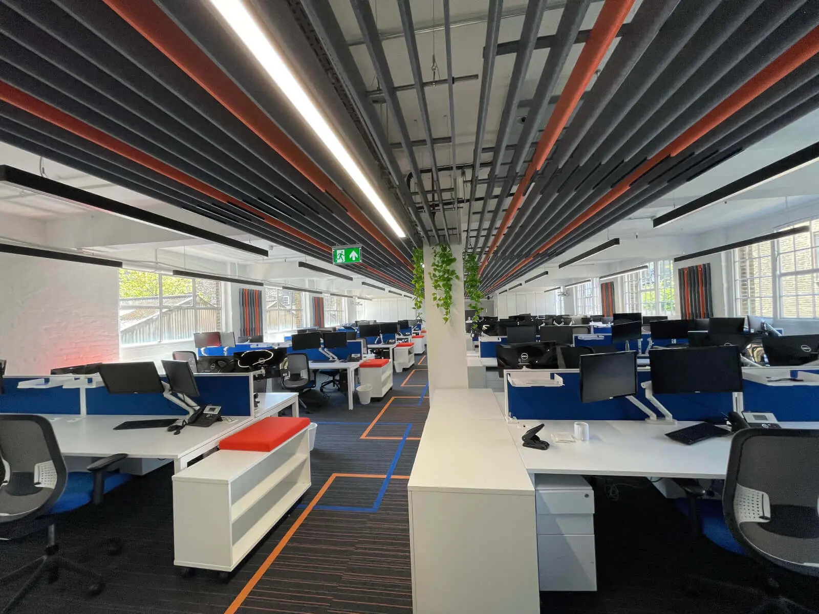 Mendik Waring office space design with designer flooring, acoustic ceiling and black framed glass partitions 9