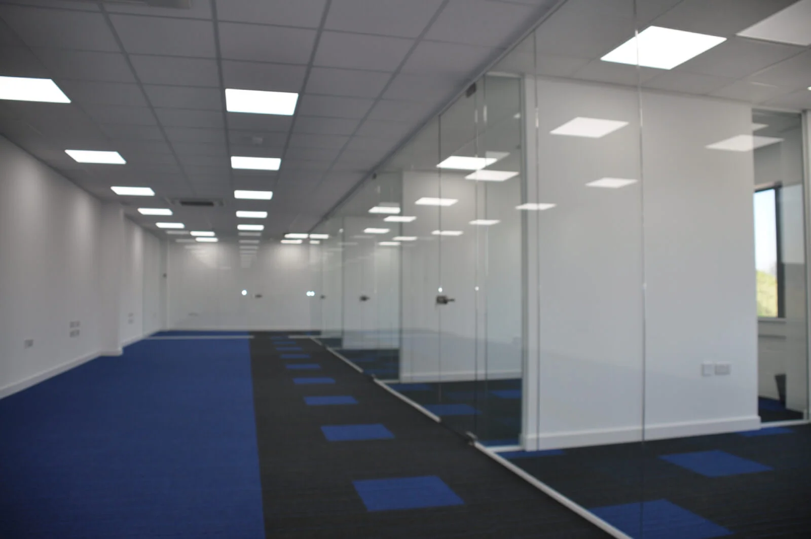 Nasco office space with designer flooring and single glazed solid stud wall glass partitions 11