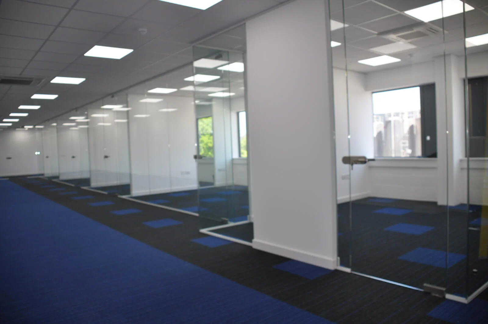 Nasco office space with designer flooring and single glazed solid stud wall glass partitions 12