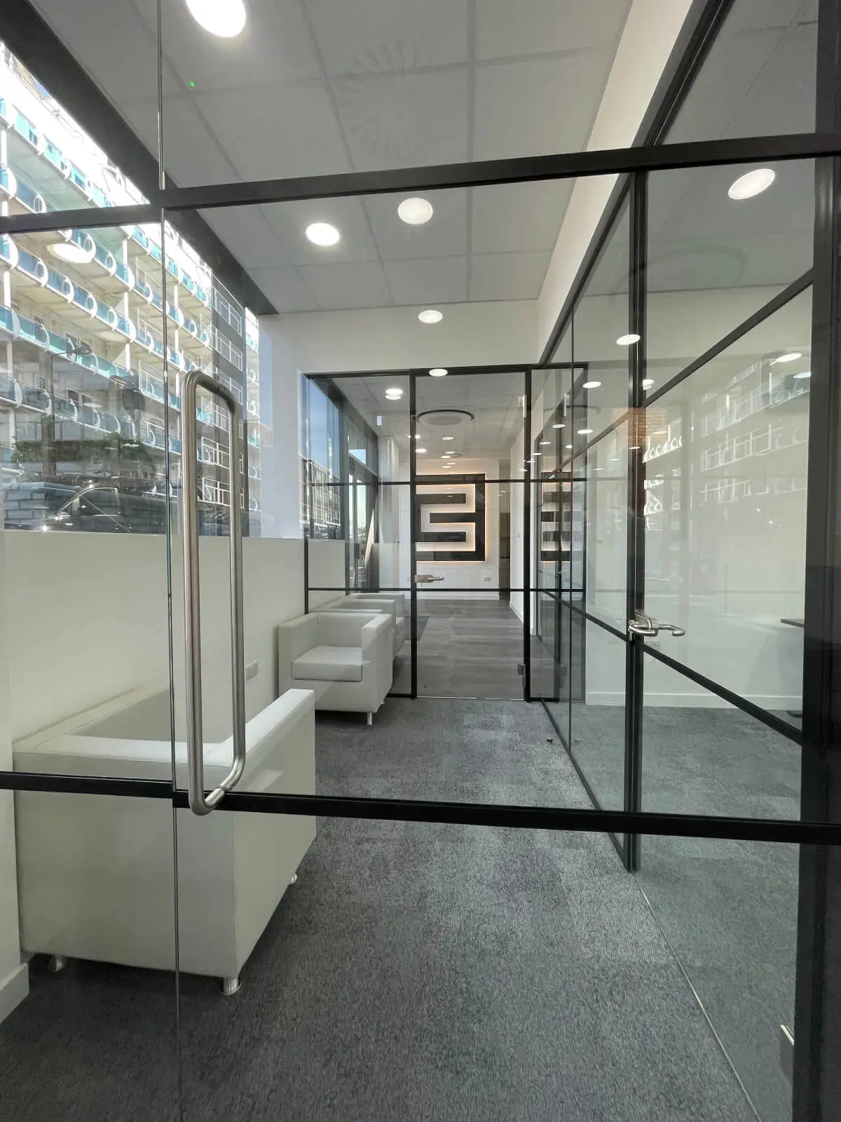 Carter Bond space design with suspended grid ceiling black framed glass partitions 11