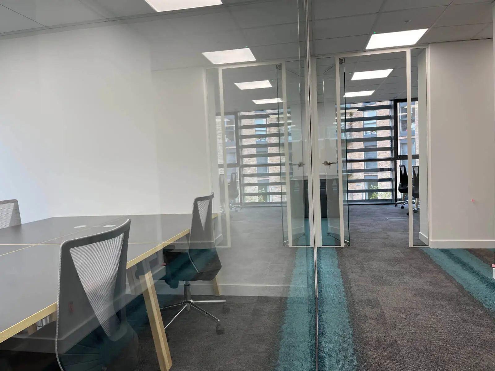 Godleys office space design with designer furniture and single glazed framed glass partitions 28