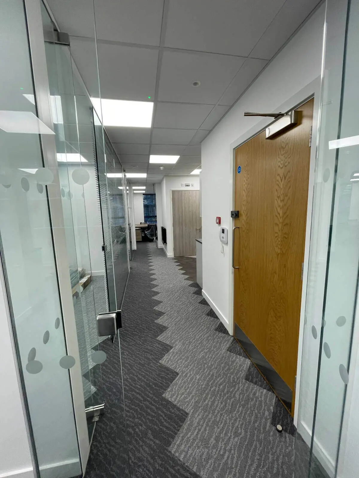 Hemsley Miller office space with designer flooring, funriture and single glazed glass partitions 16